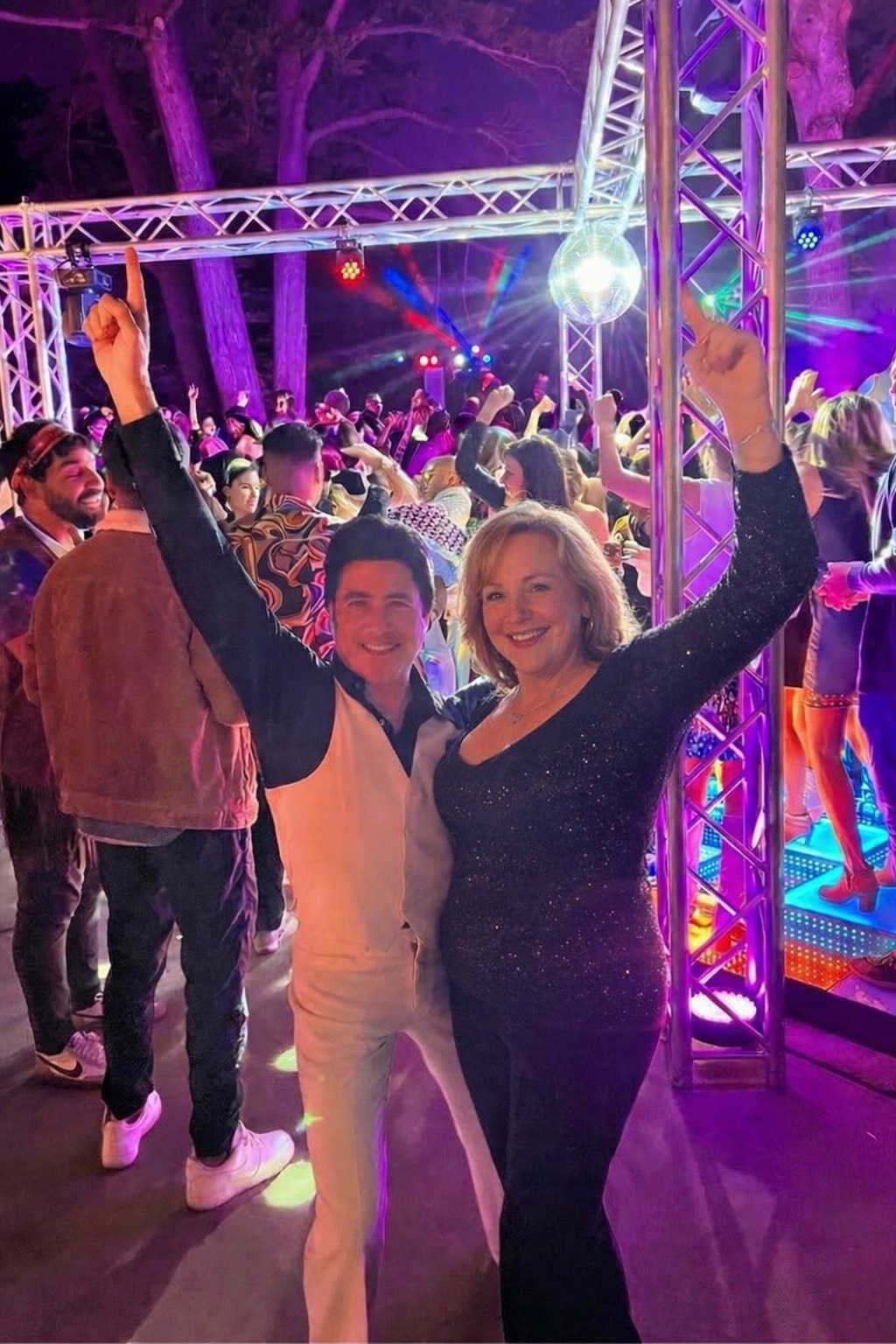 Travolta-style performer posing with a guest at a corporate event